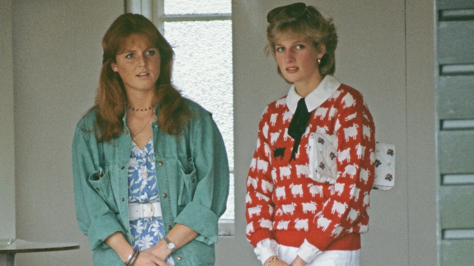 Princess Diana wearing her black sheep sweater talking to Sarah Ferguson wearing a blue and white dress with a green blazer