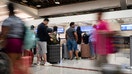Travelers are seen in a United Airlines check in line ahead of the fourth of July holiday weekend at Hartsfield-Jackson Atlanta International Airport on June 30, 2023, in Atlanta, Georgia. 